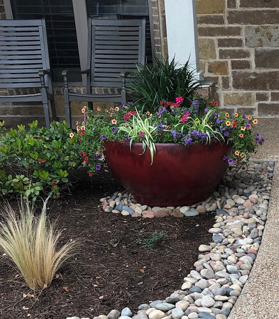 Plantings and rock and mulch installed for landscape bed in China Spring, TX.