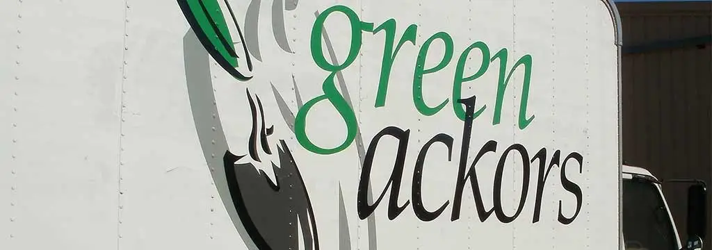 Green Ackors Landscaping & Irrigation service truck with branding at a property in Woodway, TX.