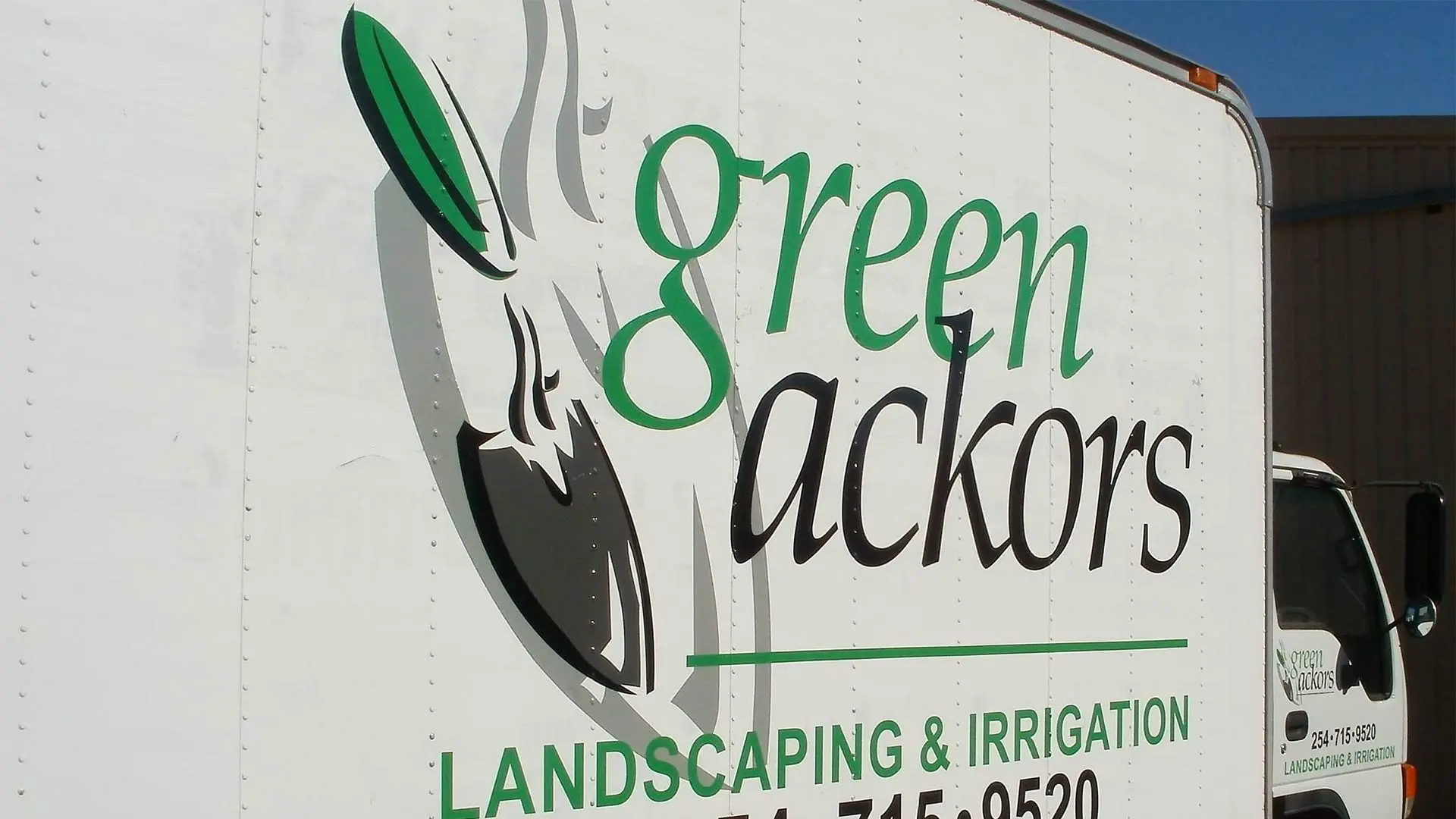 Green Ackors Landscaping & Irrigation work truck with logo branding near Waco, TX.