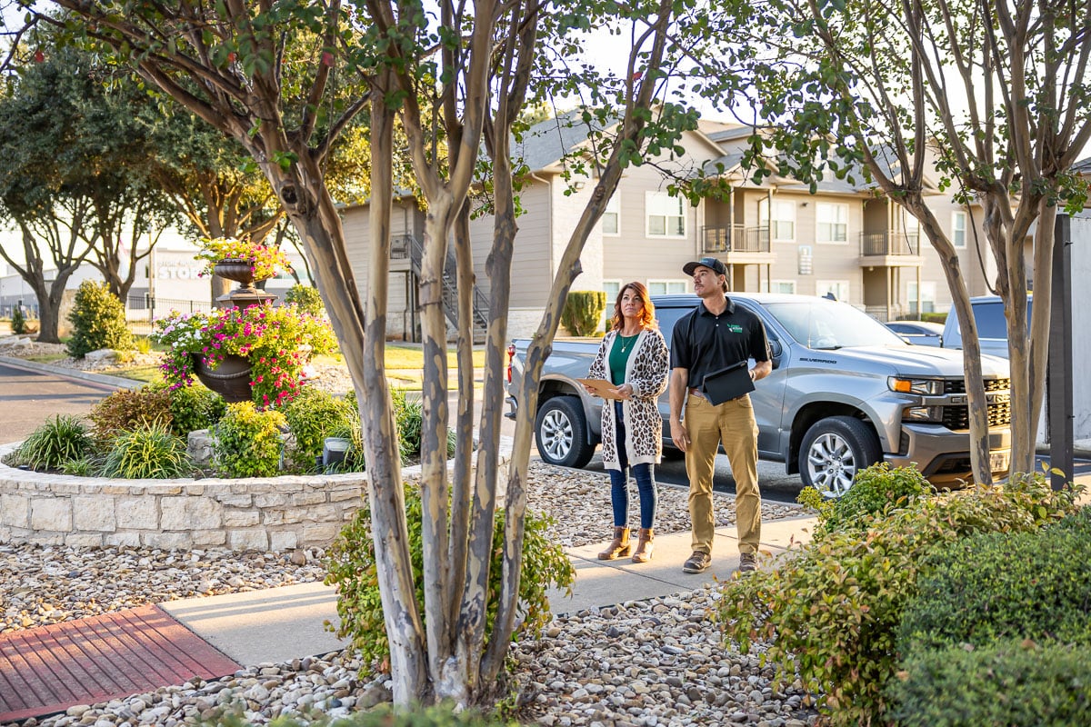 Account manager and property manager walking inspection apartment complex 2