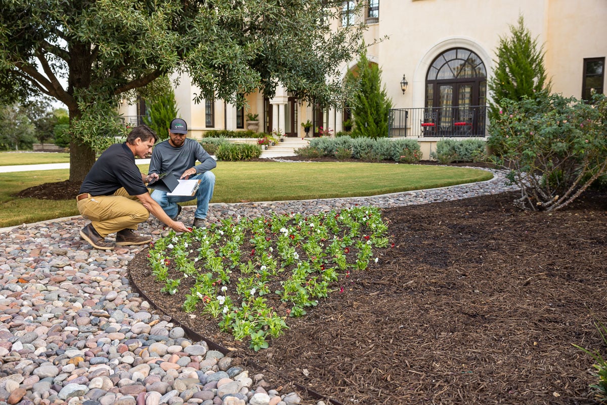 Account manager inspecting residential property with operations manager annuals