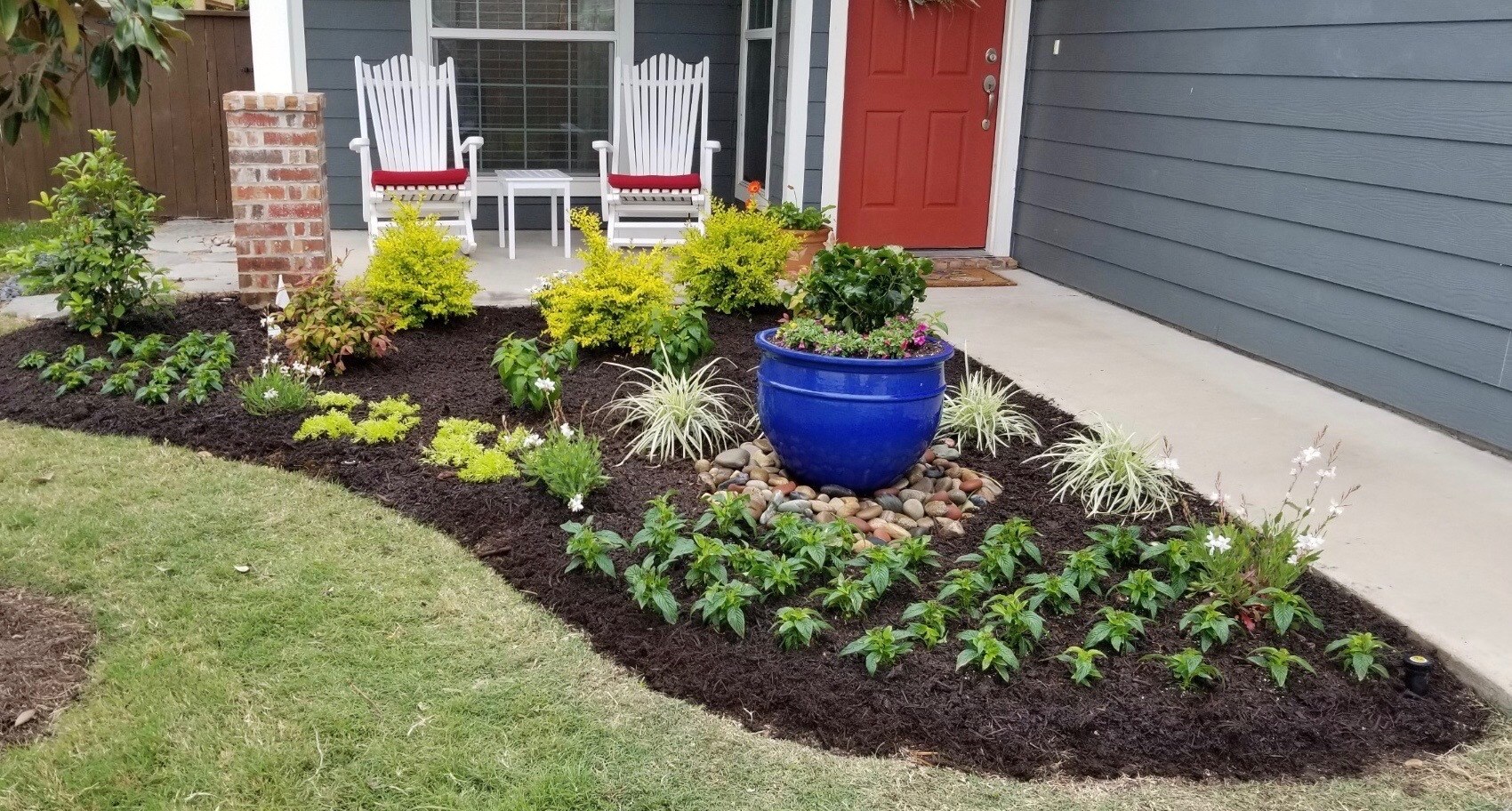 Landscape bed fresh mulch front of house 