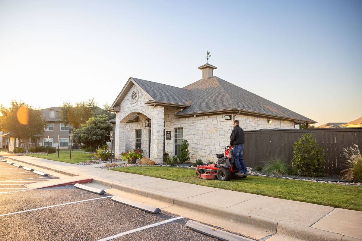 Commercial maintenance apartment complex crew mowing 13