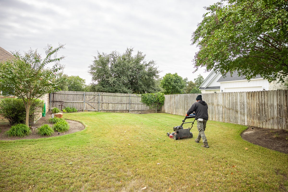 Landscape maintenance crew mowing backyard 1