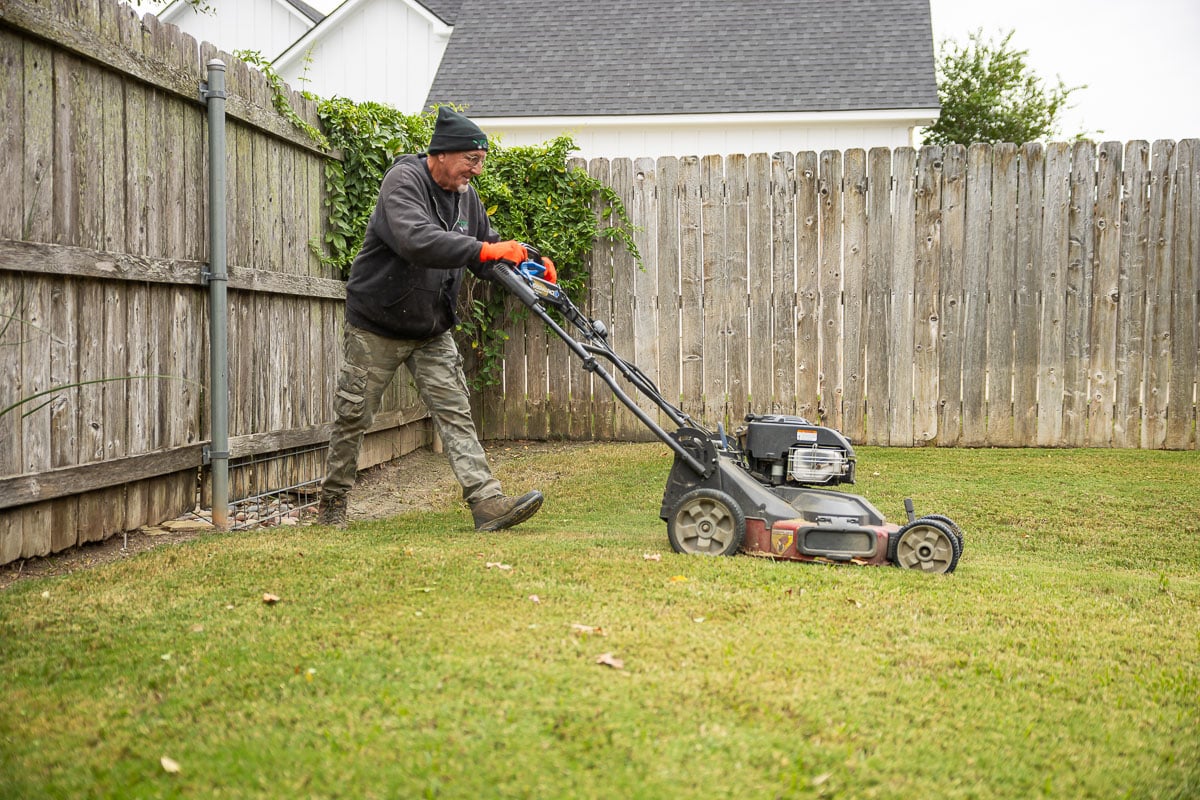 Landscape maintenance crew mowing lawn