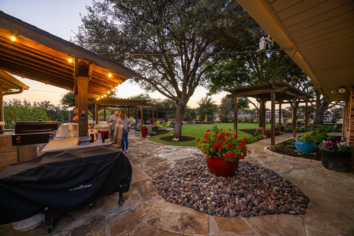Outdoor kitchen  family customer pergola green lawn landscape beds outdoor lighting 