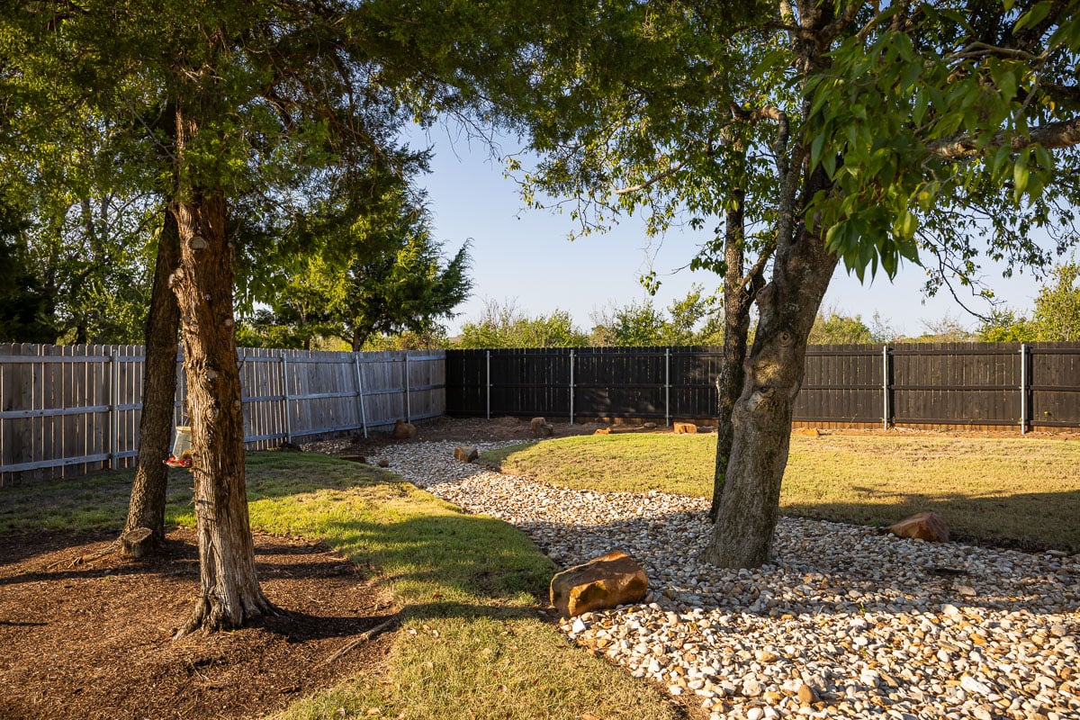 Residential dry creek landscape trees