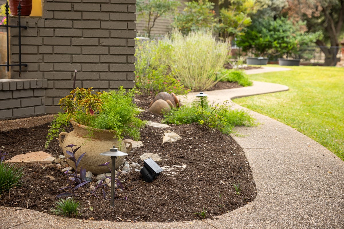 Residential landscape fresh mulch flowers garden bed 1