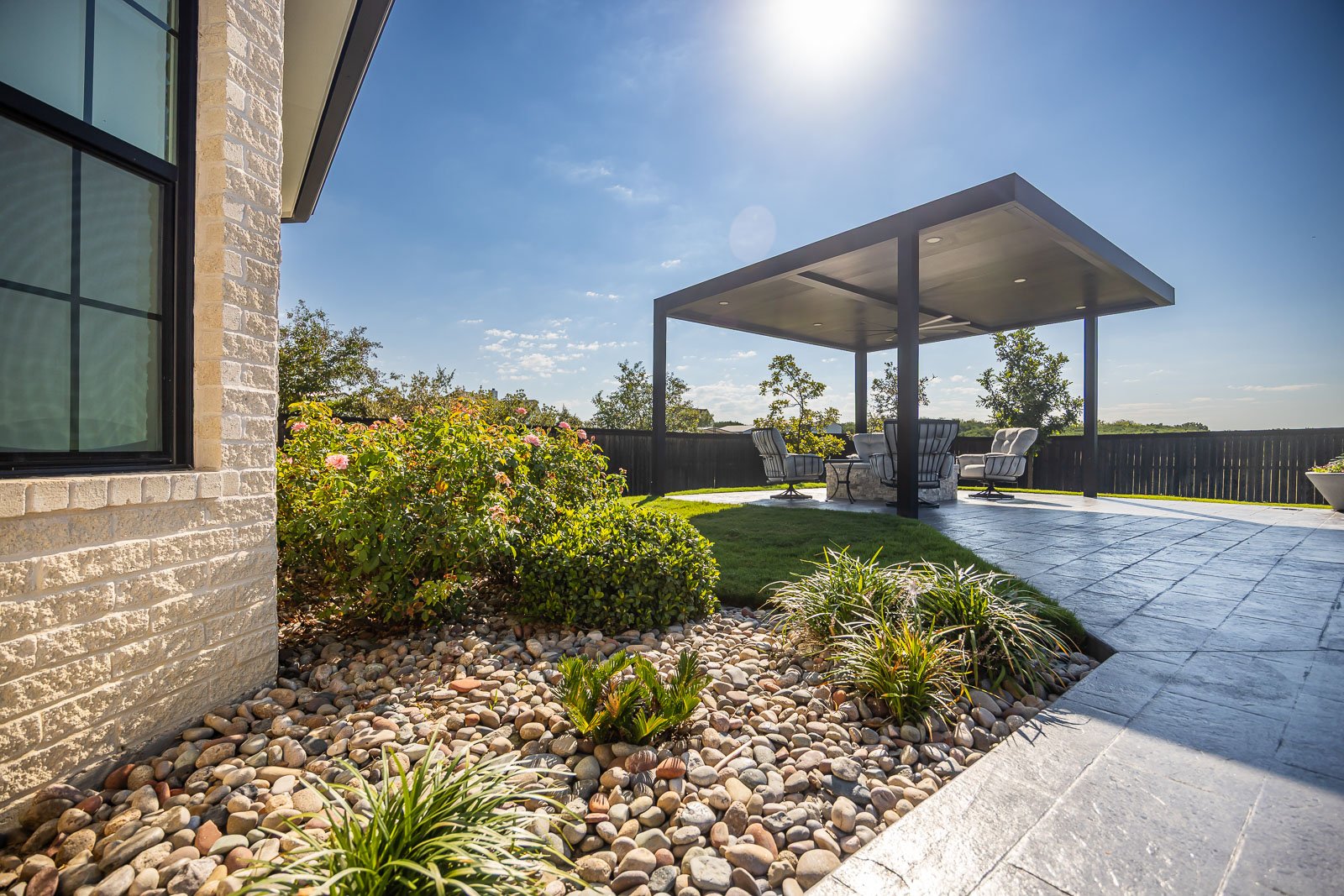 back of house landscape beds green lawn pergola patio