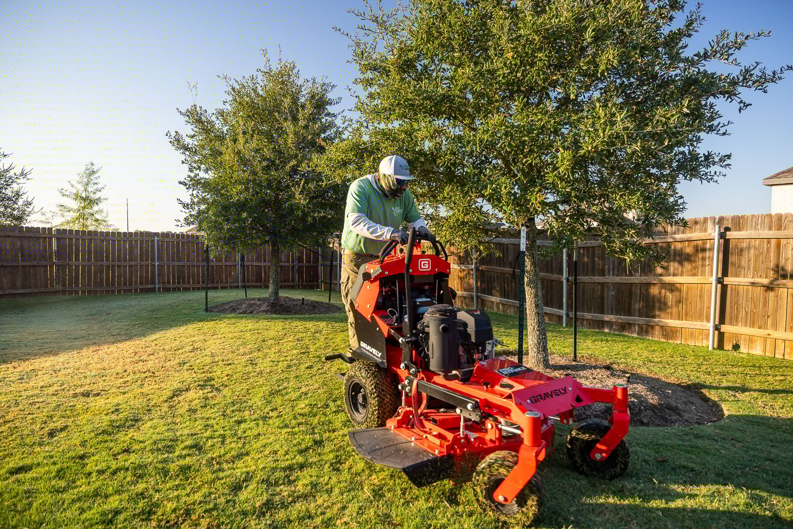 back of house landscaping crew maintenance mowing lawn 5