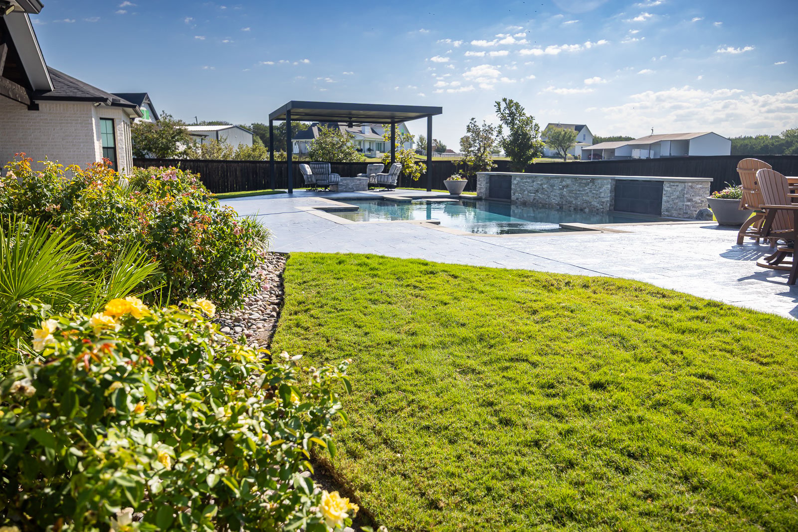 back yard pool patio pergola green lawn and landscape beds