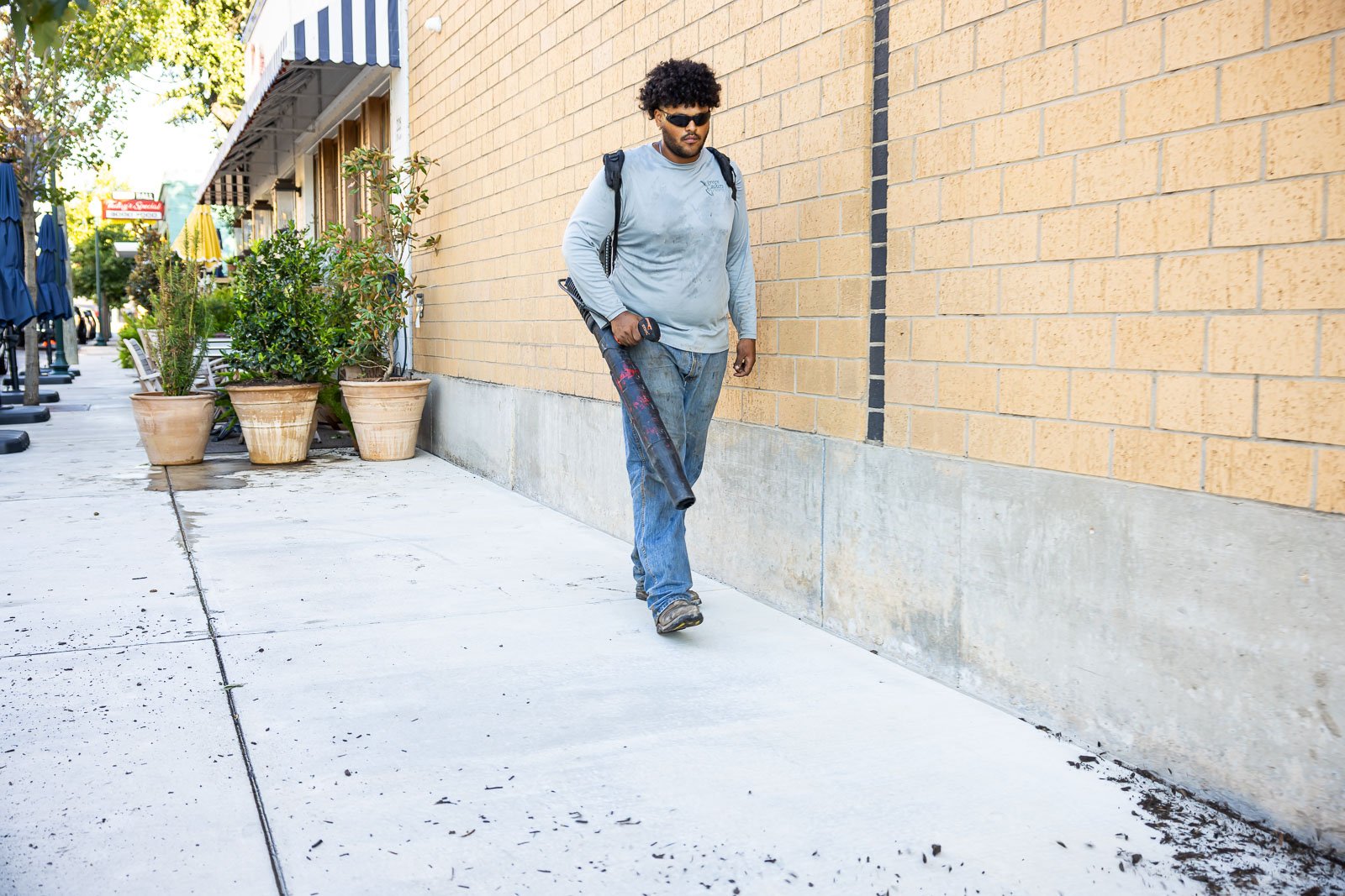 commercial maintenance cre blowing off sidewalk