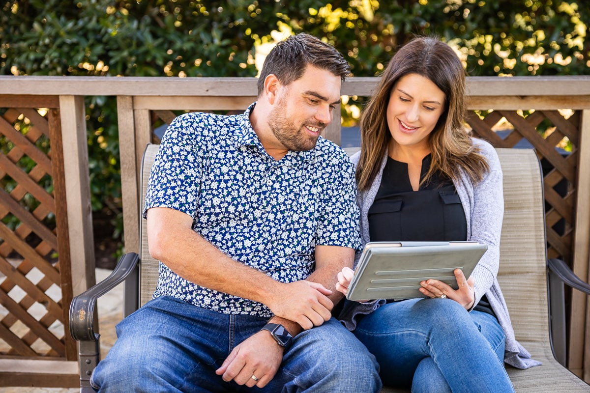 customers sitting on patio looking at tablet 4