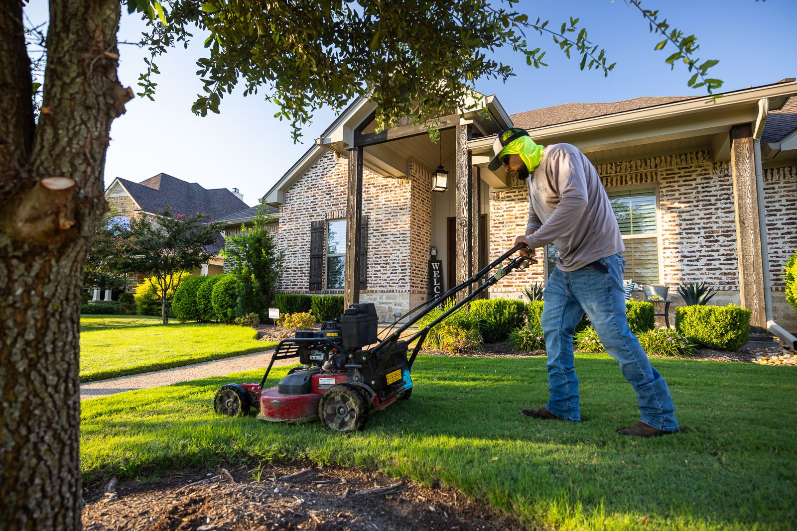 front of house landscaping crew maintenance mowing lawn 2