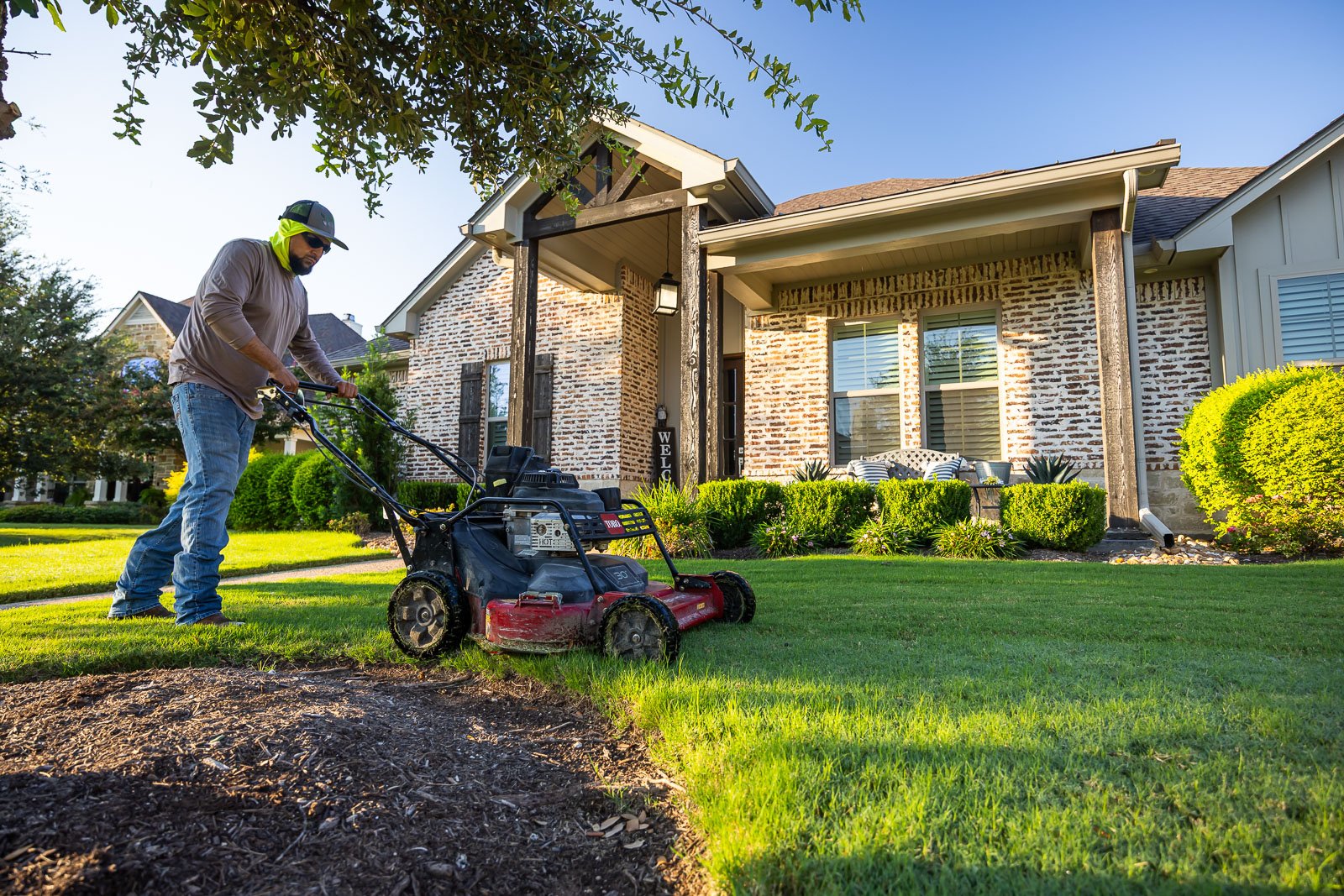 front of house landscaping crew maintenance mowing lawn 3