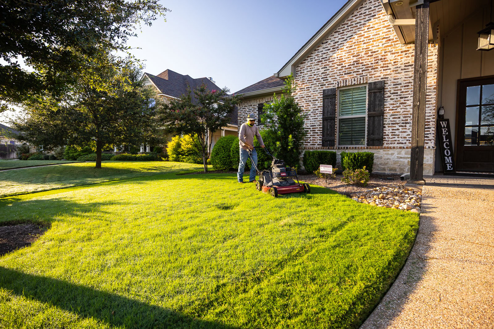 front of house landscaping crew maintenance mowing lawn 8