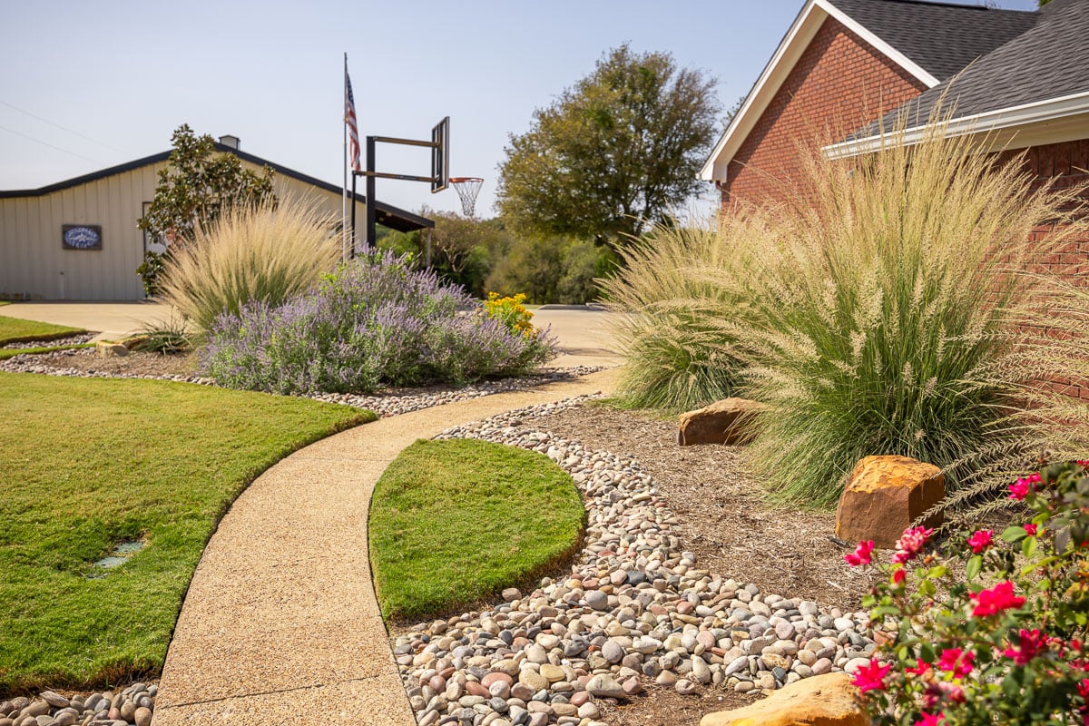 landscape beds green lawn backetball hoop sidewalk 