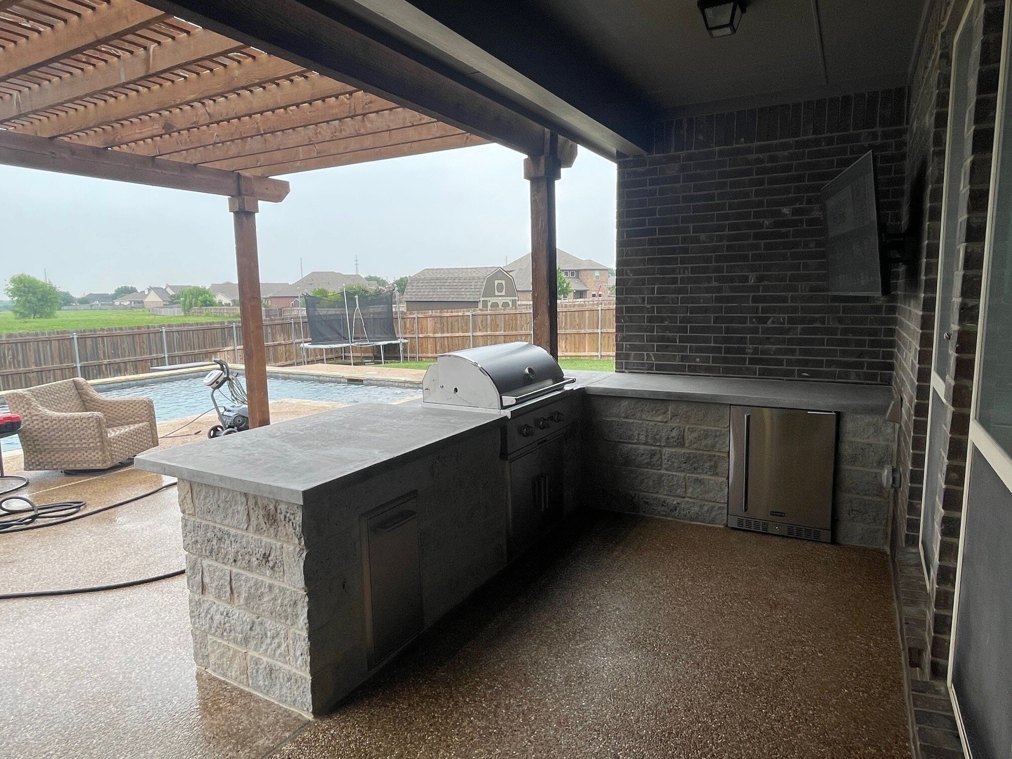 outdoor kitchen concrete patio stone counter grill bbq pergola pool