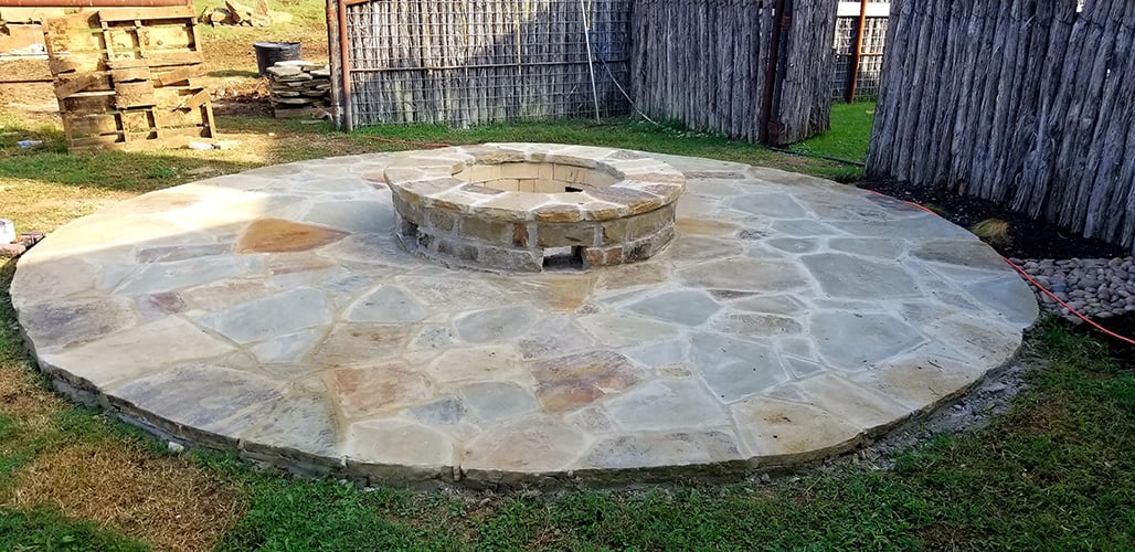 stone patio firepit fence in progress
