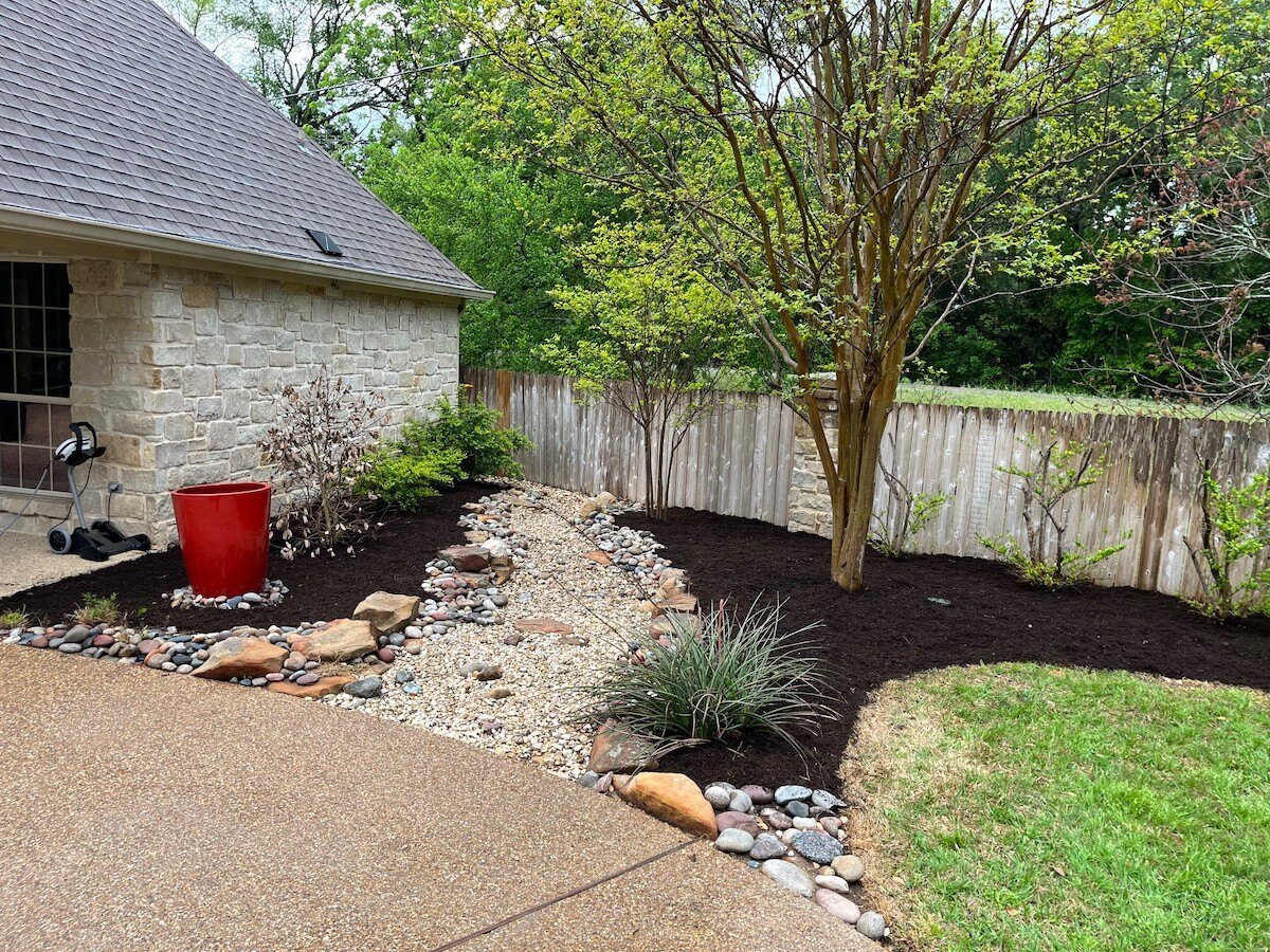 Dry creekbed in front landscape beds front of house