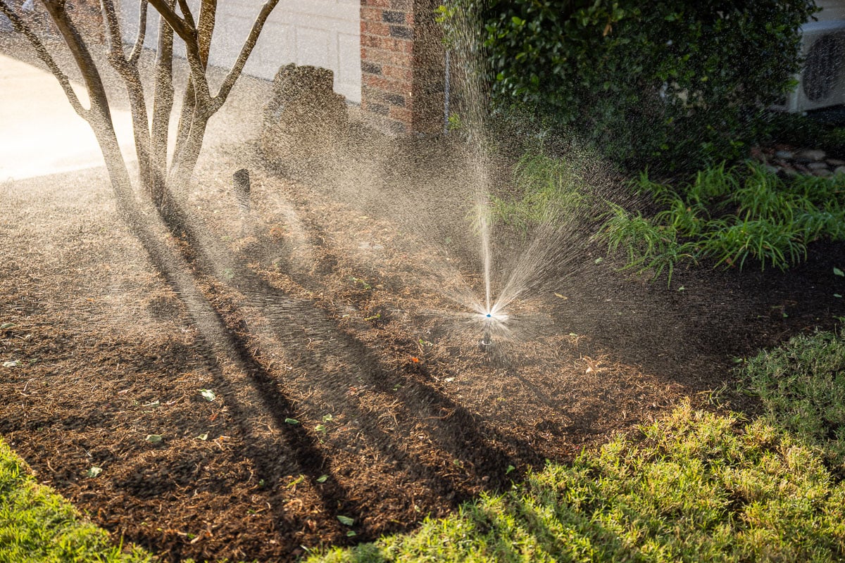 Residential maintenance irrigation sprinklers watering lawn landscape beds 1