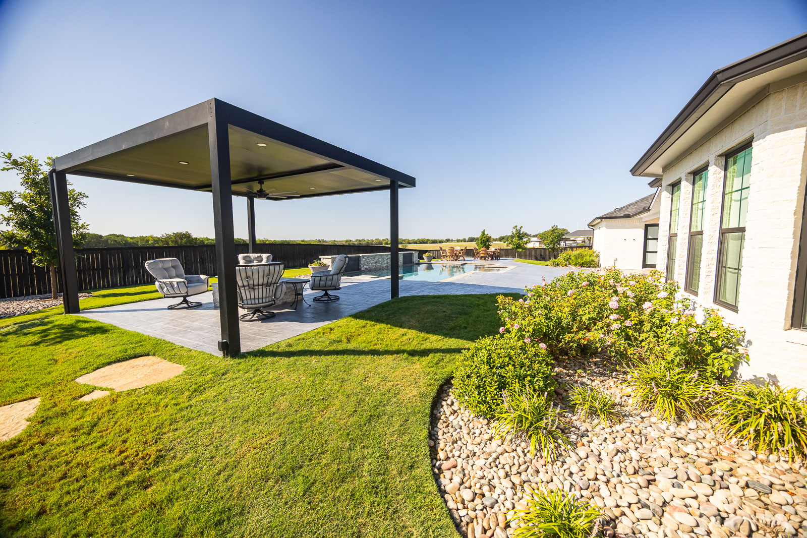 back of house landscape beds green lawn pergola patio pool