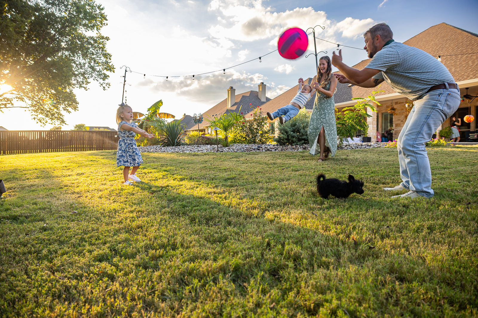 family playing backyard lawn landscape beds 3