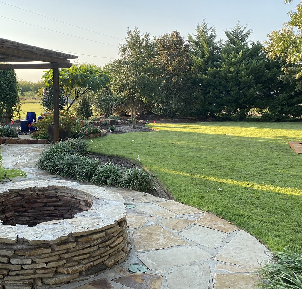 https://47688315.fs1.hubspotusercontent-na1.net/hubfs/47688315/firepit%20stone%20patio%20perennials%20pergola%20grass%20turf%20lawn%20trees%20mulch%20beds.jpg