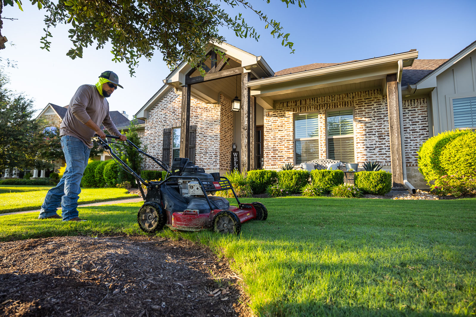 front of house landscaping crew maintenance mowing lawn 3