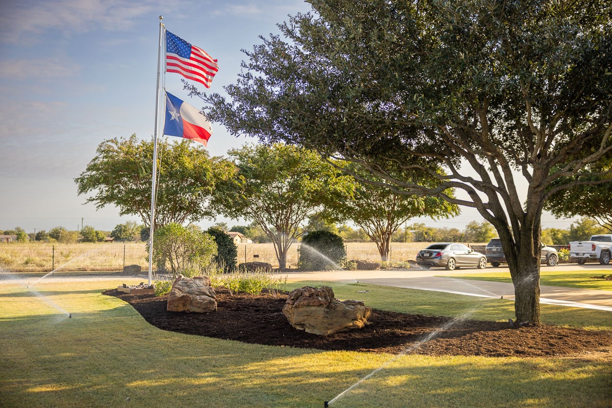 green lawn landscape beds flags irrigation watering 