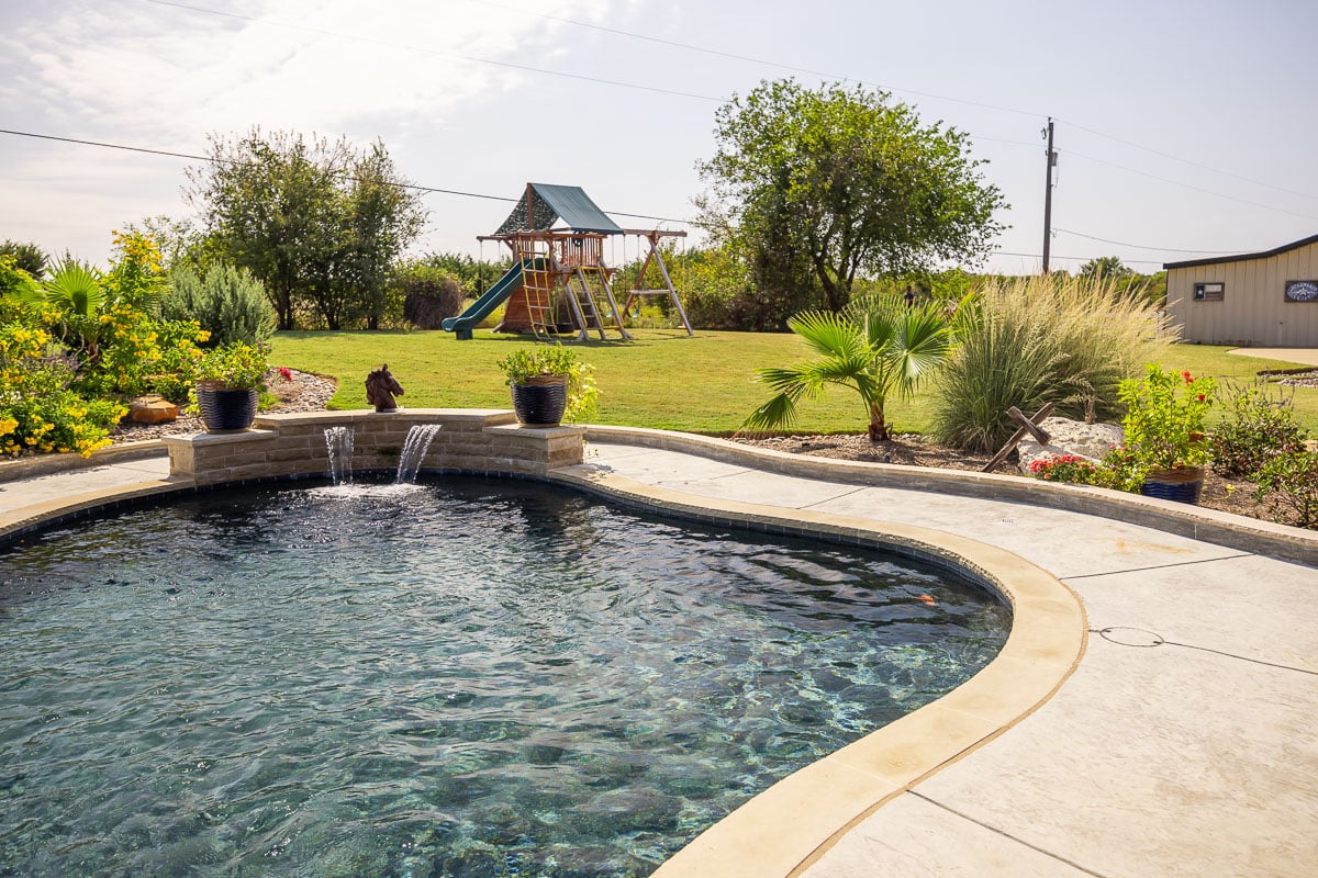 landscape design pool patio landscape beds fountain green lawn 