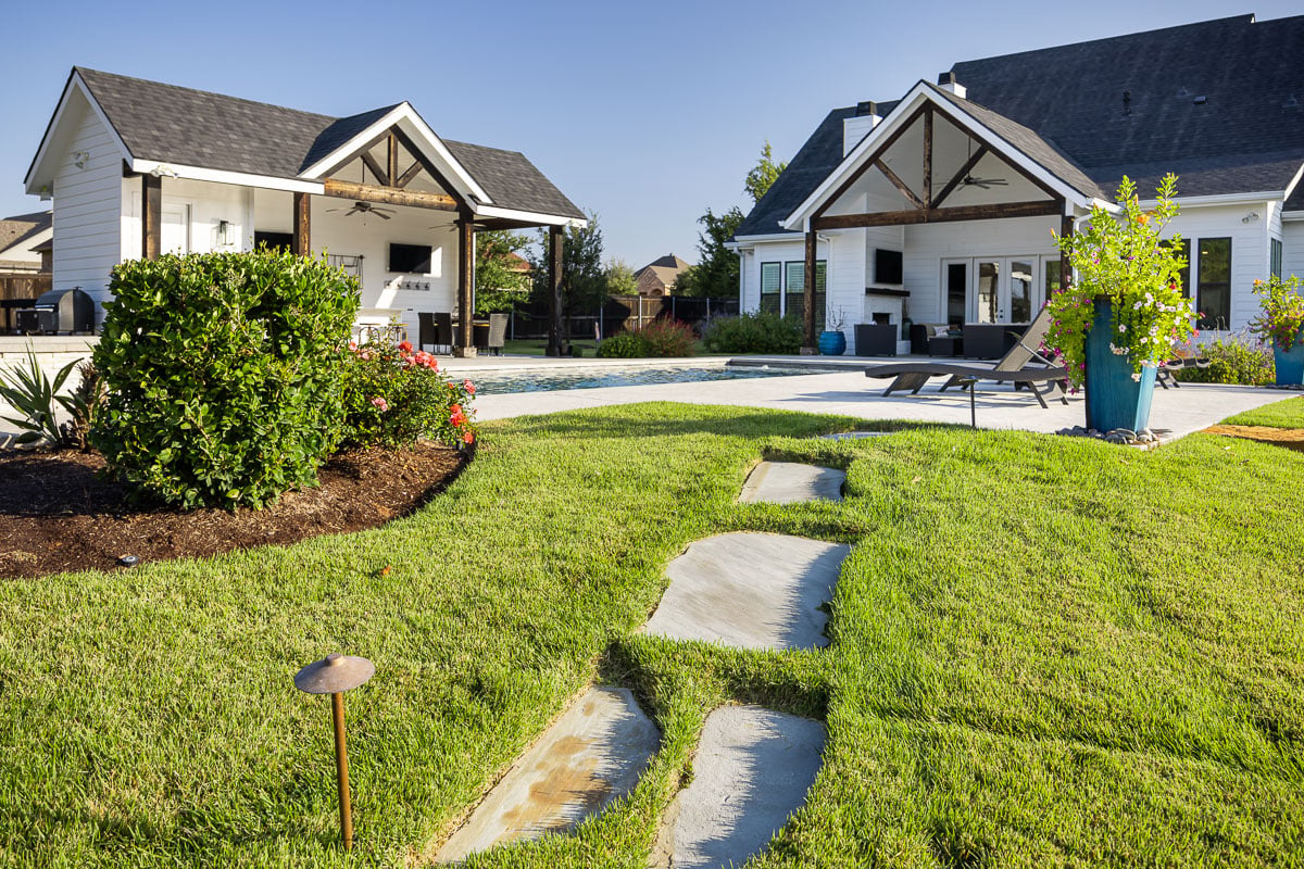 paver walkway green lawn backyard pool patio house 