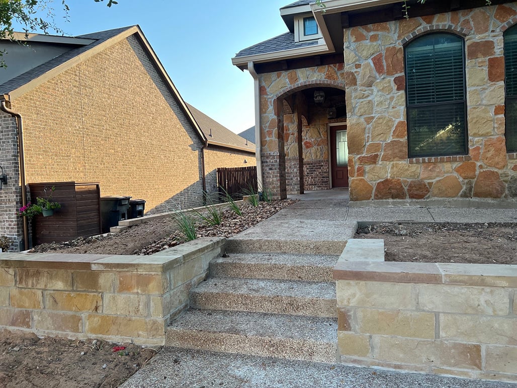 stone wall concrete steps front entry path in progress construction